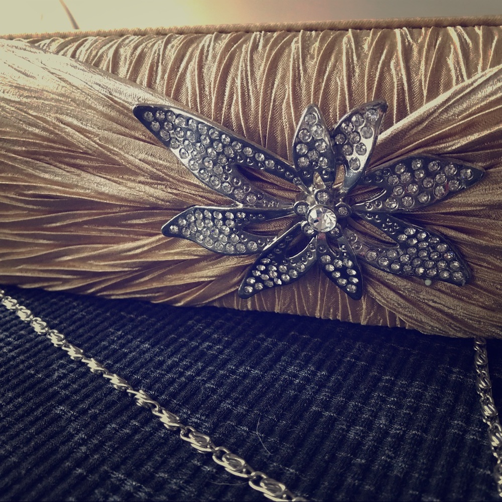 Gorgeous gold clutch with rhinestone brooch